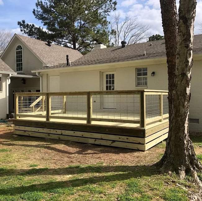 New pressure-treated wood deck with cable railing on a Spokane area home